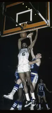  ?? PHOTO: GETTY IMAGES ?? Boston Celtics centre Bill Russell slam dunks the ball against Los Angeles Lakers players Leroy Ellis and Rudy LaRusso during their NBA game in Boston in 1966.