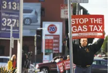  ?? Paul Chinn / The Chronicle 2017 ?? Anthony Ballester protests the 12-cents-per-gallon gas tax at Fell and Divisadero streets in San Francisco in November.