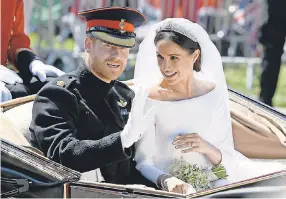  ?? JEFF J MITCHELL/GETTY IMAGES ?? Prince Harry and Meghan, now the Duke and Duchess of Sussex, leave Windsor Castle by carriage for a procession around Windsor, England, after getting married at St George’s Chapel on Saturday.