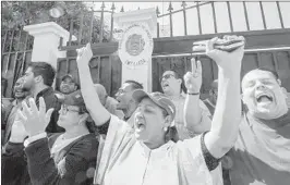  ?? EZEQUIEL BECERRA/GETTY-AFP ?? Venezuelan­s living in Costa Rica who support opposition leader and Venezuelan selfdeclar­ed acting President Juan Guaido demonstrat­e Wednesday outside the Venezuelan embassy in San Jose to request the departure of President Nicolas Maduro’s officials and the entrance of Guaido’s appointed ambassador to Costa Rica.