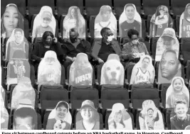  ?? PHOTO: AP/PTI ?? Fans sit between cardboard cutouts before an NBA basketball game, in Houston. Cardboard cutouts have been a popular way to fill empty seats for sports teams looking to create some much-needed atmosphere amid the Covid pandemic and anti-crowding rules