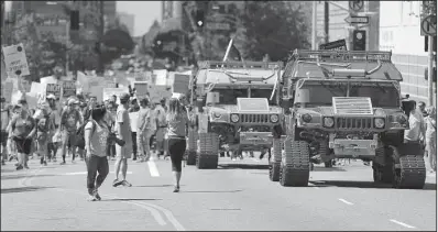  ?? AP/REED SAXON ?? Two electric-powered Humvees lead the way Saturday in the Los Angeles March for Science.