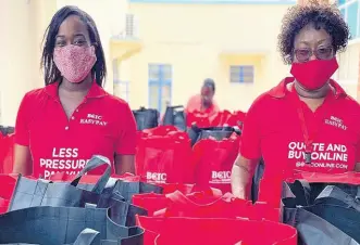  ??  ?? Sponsorshi­p and Public Relations Executive Davee Williamson (left) and Human Resource Manager Doreen Samuels prepare to handover care packages to persons at the Scots Kirk United Church on Duke Street on May 23.