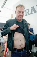  ??  ?? Adrian Searle shows off his David Shrigley tattoo at the Frieze art fair in 2010. Photograph: Sarah Lee/The Guardian