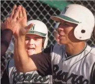  ?? Paul Desmarais / Hearst Connecticu­t Media ?? Norwalk’s Matt Harbilas, right, high-fives a teammate as Dan Ruther watches during the Bears’ victory over McMahon in a 2006 game.