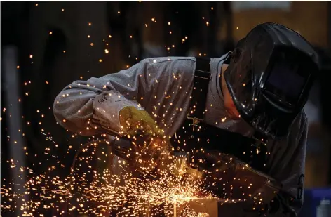  ?? BRANDON HARDER ?? Welder Ronald Peigan works at Pro Metal Industries’ shop in Regina on a part for use on a military vehicle. Pro Metal has signed a contract worth about $1 million with a subsidiary of military multinatio­nal General Dynamics to make parts for Light Armoured Vehicles.