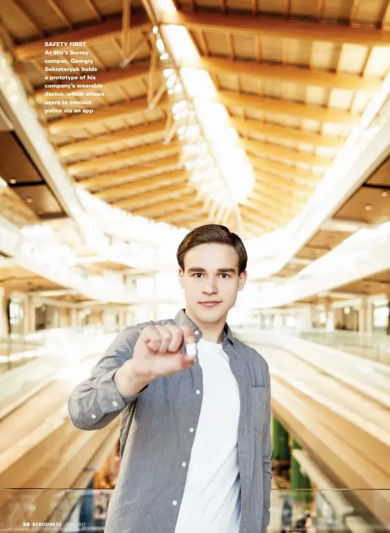  ??  ?? SAFETY FIRST At SFU'S Surrey campus, Georgiy Sekretaryu­k holds a prototype of his company's wearable device, which allows users to contact police via an app