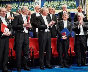  ??  ?? The last word: (From left) Laureates in physiology or medicine Jeffrey Hall, Rosbash and Michael Young as well as laureate in economics Richard Thaler applauding Ishiguro at the Nobel Award Ceremony at the Concert House in Stockholm, Sweden. — Reuters