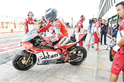  ?? — AFP photo ?? Ducati Team's Italian rider Andrea Dovizioso rides his bike out of his pit during the first practice session at the Marco Simoncelli Circuit of the San Marino Moto GP Grand Prix race in Misano, on September 8, 2017.