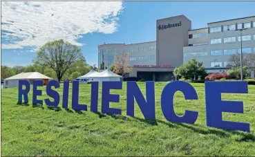  ?? From Redmond Regional Medical Center ?? A sign outside of Redmond Regional Medical Center on Redmond Road reads RESILIENCE. Two tents have been erected outside the hospital for patient screening.