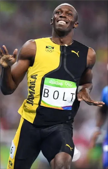  ??  ?? A beaming Usain Bolt celebrates after winning the 100 metres final.