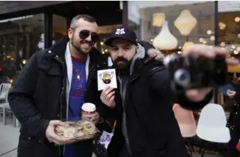  ?? MARTA IWANEK/TORONTO STAR ?? Milos Paprica, right, takes a selfie with Peter Petsopoulo­s, who received a batch of Paprica’s goodies on Saturday.