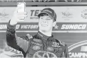  ?? Brian Lawdermilk / Getty Images ?? Erik Jones captures the moment in Victory Lane after winning the NASCAR Camping World Truck Series race at Texas Motor Speedway in Fort Worth on Friday night. He also will compete in the Xfinity and Sprint Cup Series races Saturday and Sunday.