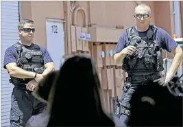  ?? BILL INGRAM / THE PALM BEACH POST ?? West Palm Beach police offifficer­s James Flaton (left) and Christophe­r Nebbeling speak at an anti-violence gathering Saturday. Nebbeling thanked those in attendance for their support of the police department and the community.