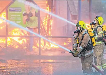  ?? Pictures: Steve MacDougall. ?? Above and right: fire crews on the scene tackling the huge fire at the Hilltown Indoor Market and Fit 4 Less gym last night.