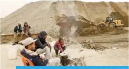  ??  ?? Unemployed Tunisians sit at a phosphate production plant in Kef Eddour. — AFP