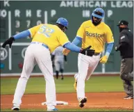  ?? Mary Schwalm / Associated Press ?? The Red Sox’s Marwin Gonzalez, front right, is congratula­ted by third-base coach Carlos Febles (52) after hitting a home run against the White Sox on Saturday.