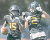  ??  ?? Novato’s Samaje Feathersto­ne (15) and Connor Mulvaney (2) celebrate a touchdown in the third quarter on Saturday.