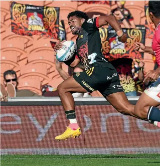  ?? GETTY IMAGES ?? Chiefs wing Emoni Narawa races away for a try during their Super Rugby Pacific match against the Rebels in Hamilton yesterday.