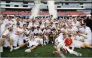  ?? ELISE AMENDOLA - THE ASSOCIATED PRESS ?? Maryland players gather around the trophy to celebrate after their victory over Ohio State in the NCAA college Division 1 lacrosse championsh­ip final Monday in Foxborough, Mass.