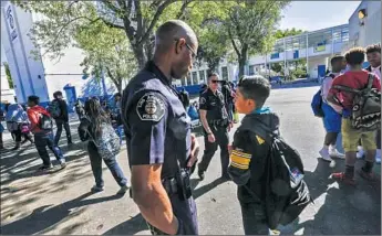  ?? Photograph­s by irfan khan Los Angeles Times ?? SCHOOLS are increasing­ly calling on officers like Henry Anderson at Robert E. Peary Middle School in Gardena to handle discipline issues, another officer says. Suspension­s are no longer allowed for defiance.