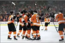  ?? MATT SLOCUM — THE ASSOCIATED PRESS ?? The Flyers’ Sean Couturier (14) celebrates with Scott Laughton (21), Michael Raffl (12), Ivan Provorov (9) and Jori Lehtera (15) after Couturier scored the winning goal overtime Thursday in Philadelph­ia. in