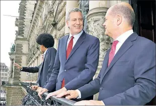  ??  ?? HAMBURGER MEISTERS: On one of his 63 trips, Mayor de Blasio visits Mayor Olaf Scholz at City Hall in Hamburg, Germany, in July 2017 with son Dante behind him.