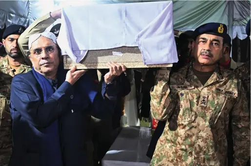  ?? — afp ?? Pakistan’s Army Chief General Syed Asim Munir and Pakistan’s President Asif Ali Zardari carrying the coffin of captain Muhammad Ahmed Badar, who was killed along with other soldiers in a militant attack in north Waziristan district, during the funeral ceremony at Chaklala garrison in Rawalpindi.