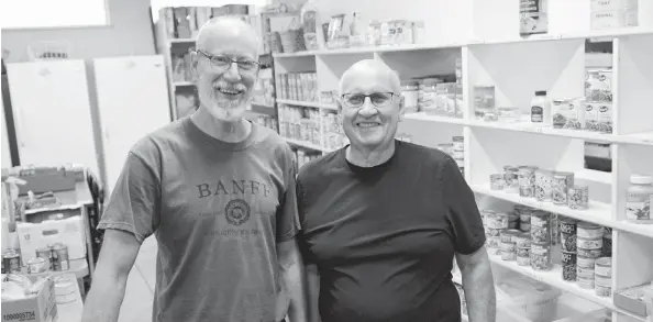  ?? [FAISAL ALI / THE OBSERVER] ?? WCS is looking for much-needed donations this Thanksgivi­ng to restock the local food bank’s shelves. Here, volunteers John Mathers and Elroy Wideman sort items at the food bank at 5 Memorial Ave. in Elmira.