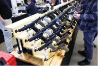  ?? REUTERS FILE ?? Customers shop for handguns at a gun show in Des Moines, Iowa. In the US, there are more firearms than people.—