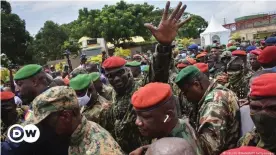  ??  ?? Guinea's coup leader Mamadi Doumbouya waves to the crowd as he arrives at the Palace of the People in Conakry