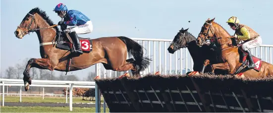  ?? PA. ?? King’s Walk, ridden by Harry Cobden, jumps clear on the way to winning The Back Or Lay On Betdaq Handicap Hurdle at Kempton.