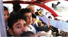  ?? Reuters ?? A health worker takes the temperatur­e of people riding a taxi van, amid concerns of the spread of the coronaviru­s disease, at the main entrance to Sanaa.