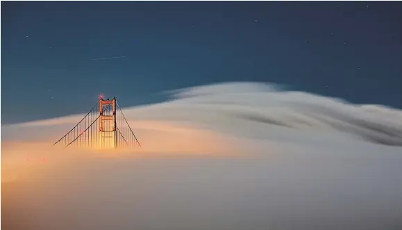  ?? NINA RIGGIO FOR THE NEW YORK TIMES ?? On Northern California’s coast, fog helps keep temperatur­es cool and enriches the area’s identity. The Golden Gate Bridge in San Francisco.