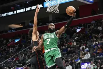  ?? Paul Sancya/Associated Press ?? Celtics guard Jaylen Brown drives on Pistons guard Cade Cunningham in the first half of the game in Detroit on Friday.