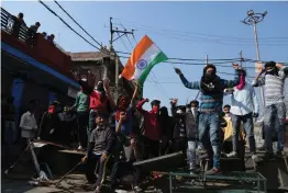  ?? — AP ?? Protesters shout slogans against Pakistan during the second day of curfew in Jammu on Saturday. The Army staged flag marches in sensitive localities a day after violence was reported during protests against the Pulwama terror attack.