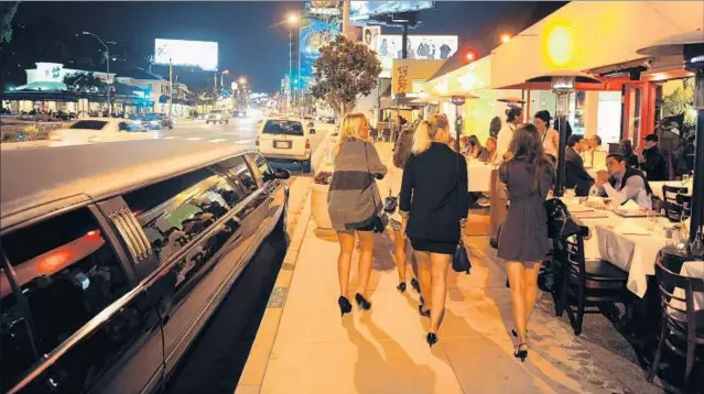  ?? Wally Skalij Los Angeles Times ?? SUNSET BOULEVARD, the backdrop for an endless parade of limos, high heels and clubs, has been a world-renowned center of nightlife for decades.