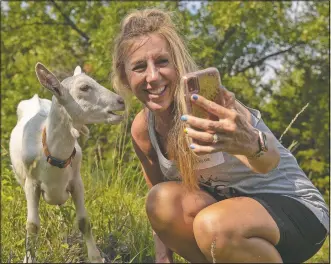  ??  ?? Teresa Nichols of Omaha, Neb., snaps a selfie with Molly the goat as they hike around the Loess Hills.