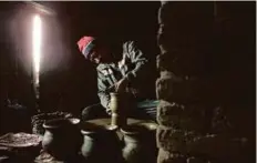  ?? AP ?? Prajapati potter Dil Krishna Prajapati, 54, moulds a clay pot in the ancient Nepalese town of Thimi. Dil Krishna said he fears that the tradition will fade away.