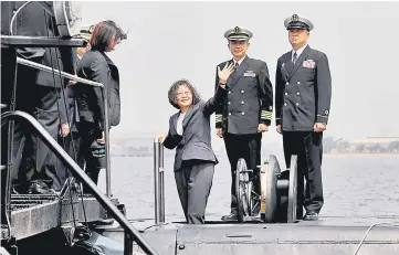  ??  ?? Tsai waves as she boards Hai Lung-class submarine (SS-794) during her visit to a navy base in Kaohsiung. — Reuters photo