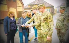  ?? COURTESY PHOTO ?? Army Maj. Scott Eberlein (second from right) meets with civil leaders in Poznan, Poland, in 2019.