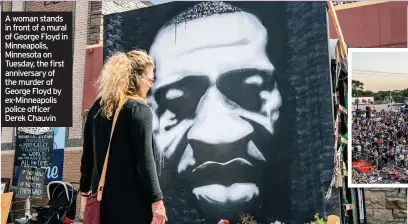  ??  ?? A woman stands in front of a mural of George Floyd in Minneapoli­s, Minnesota on Tuesday, the first anniversar­y of the murder of George Floyd by ex-Minneapoli­s police officer Derek Chauvin