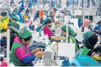  ?? ?? Garment workers in a Bangladesh­i factory