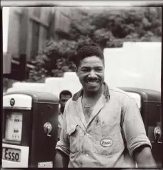  ??  ?? Charles “Teenie” Harris’ portrait of Kenneth Hawthorne wearing an Esso uniform shirt, standing in front of Esso gas pumps at Hawthorne’s Service Station, 2804 Wylie Ave., Hill District, July or August 1960.