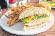  ?? GABBY PEYTON PHOTO ?? Kazu’s panko crusted chicken sandwich with crispy fries.