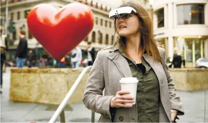  ?? AP FOTO / ERIC RISBERG ?? THEY WORK, YOU SEE. Artist Yvonne Felix wears eSight electronic glasses and looks around Union Square during a visit to San Francisco. Felix was diagnosed with Stargardt’s disease after being hit by a car at the age of seven. With the glasses, she saw...