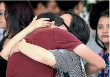  ?? AP ?? Mourners embrace at the funeral in Mexico for a victim of the 2019 El Paso shooting, who had crossed the border into the US to shop at Walmart.