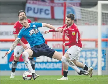  ?? ?? Posh defender Josh Knight (left) battles with Dan Crowley of Morecambe.