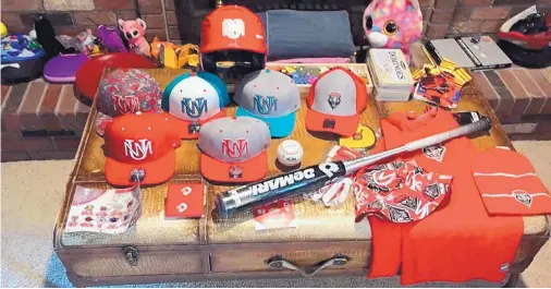  ?? COURTESY OF RAY BIRMINGHAM ?? Pictured is an assortment of University of New Mexico baseball gear that the Lobos team has sent to Lio Ortega, a 3-year-old who lives in Colorado Springs and is battling brain cancer. After surgery and chemothera­py, his prognosis is good.