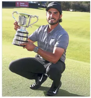  ?? — AP ?? It’s mine: Abraham Ancer of Mexico posing with his trophy after winning the Australian Open Golf tournament in Sydney yesterday.